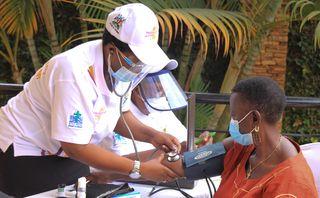 Community worker measuring blood pressure in Uganda